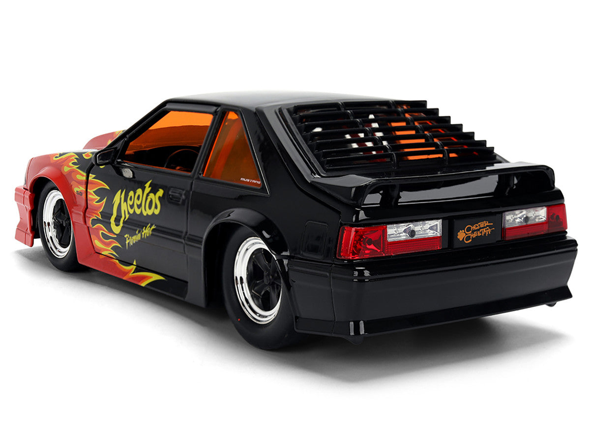 1989 Ford Mustang GT Black with Red Flame Graphics and Chester Cheetah Diecast Figure "Cheetos Flamin' Hot" "Hollywood Rides" Series 1/24 Diecast Model Car by Jada by Jada