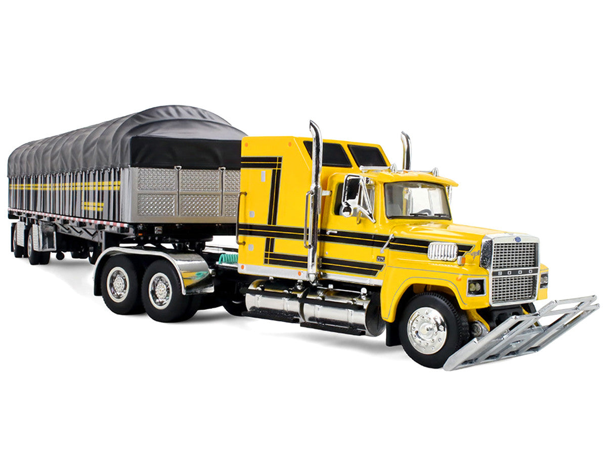 Ford LTL 9000 with 60" Aerodyne Sleeper and 53' Wilson Roadbrute Flatbed Trailer with Covered Wagon Yellow with Black Stripes 1/64 Diecast Model by DCP/First Gear by First Gear