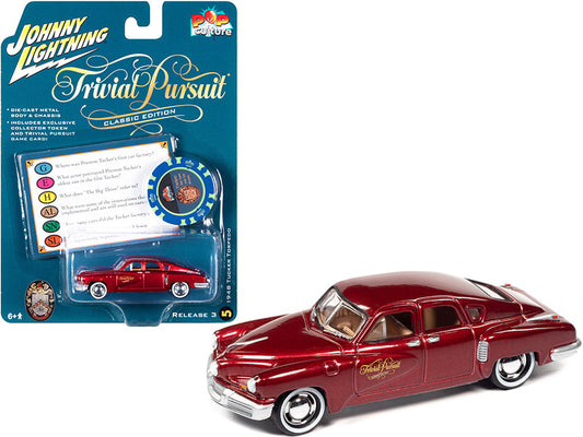 1948 Tucker Torpedo Red Maroon Metallic "Tucker: The Man and His Dream" (1988) Movie with Poker Chip (Collector Token) and Game Card "Trivial Pursuit" "Pop Culture" Series 3 1/64 Diecast Model Car by Johnny Lightning by Johnny Lightning