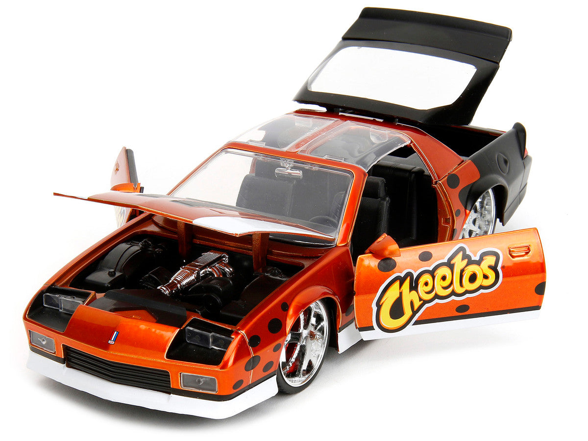 1985 Chevrolet Camaro Z/28 Orange Metallic with Graphics and Chester Cheetah Diecast Figure "Cheetos" "Hollywood Rides" Series 1/24 Diecast Model Car by Jada by Jada
